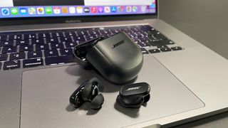 Bose QuietComfort Earbuds II in black on a MacBook