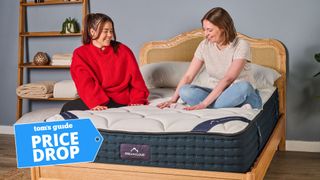 Two Tom's Guide mattress testers sat on the DreamCloud mattress
