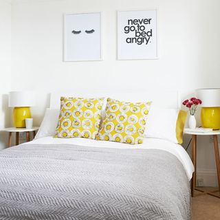 bedroom with white wall and bed with bedside table
