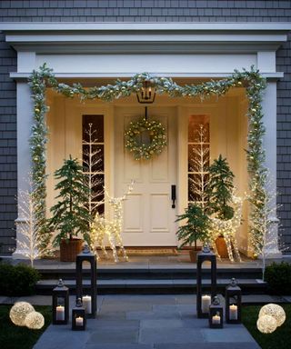 Front porch decorated with christmas lights and decor