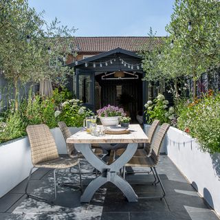 garden area with dining table and flowering plants