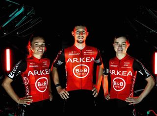 Three riders wearing the red and black team kits