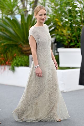 Jennifer Lawrence wears a maxi dress with a stainless steel Longines watch.