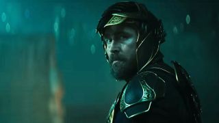 An armored Brother Day looking over his left shoulder at night in Foundation season 3