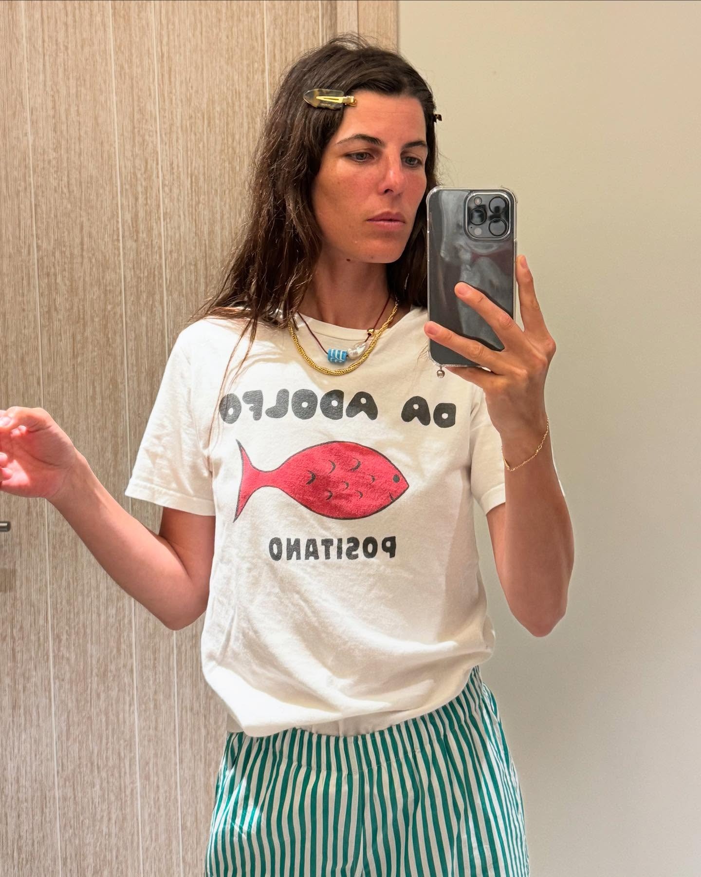 Woman in graphic tee and striped pants