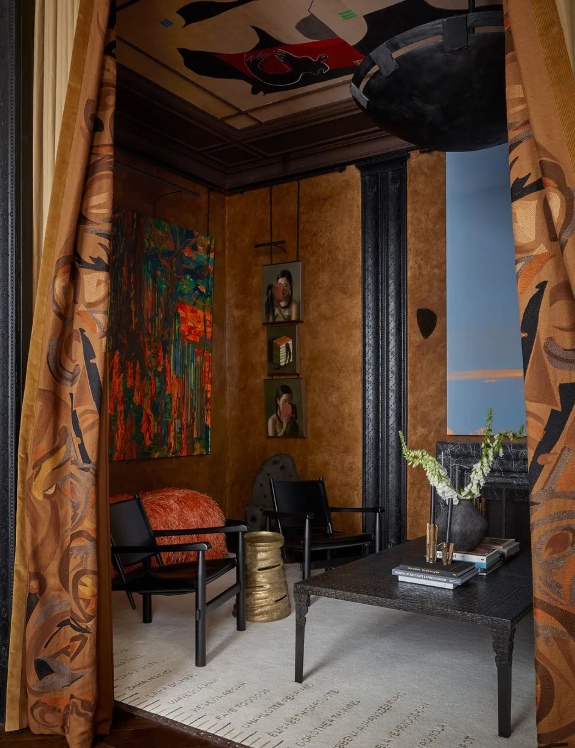 A room with textured walls and black furniture