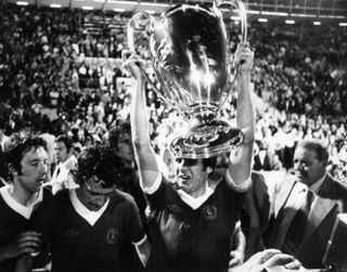 Emlyn Hughes lifts the European Cup after Liverpool's victory in the final over Borussia Monchengladbach in May 1977.