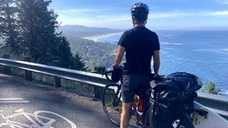 Isobel's partner with bike attached to surfboard