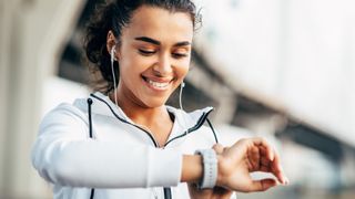 Woman checking sports watch mid-workout