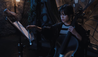 Wednesday Addams and Thing playing the cello