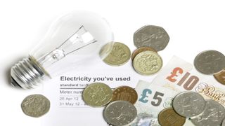 light bulb and money on top of electric bill