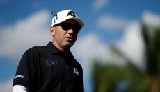 Sergio Garcia wears sunglasses and walks off the green at the LIV Golf Invitational