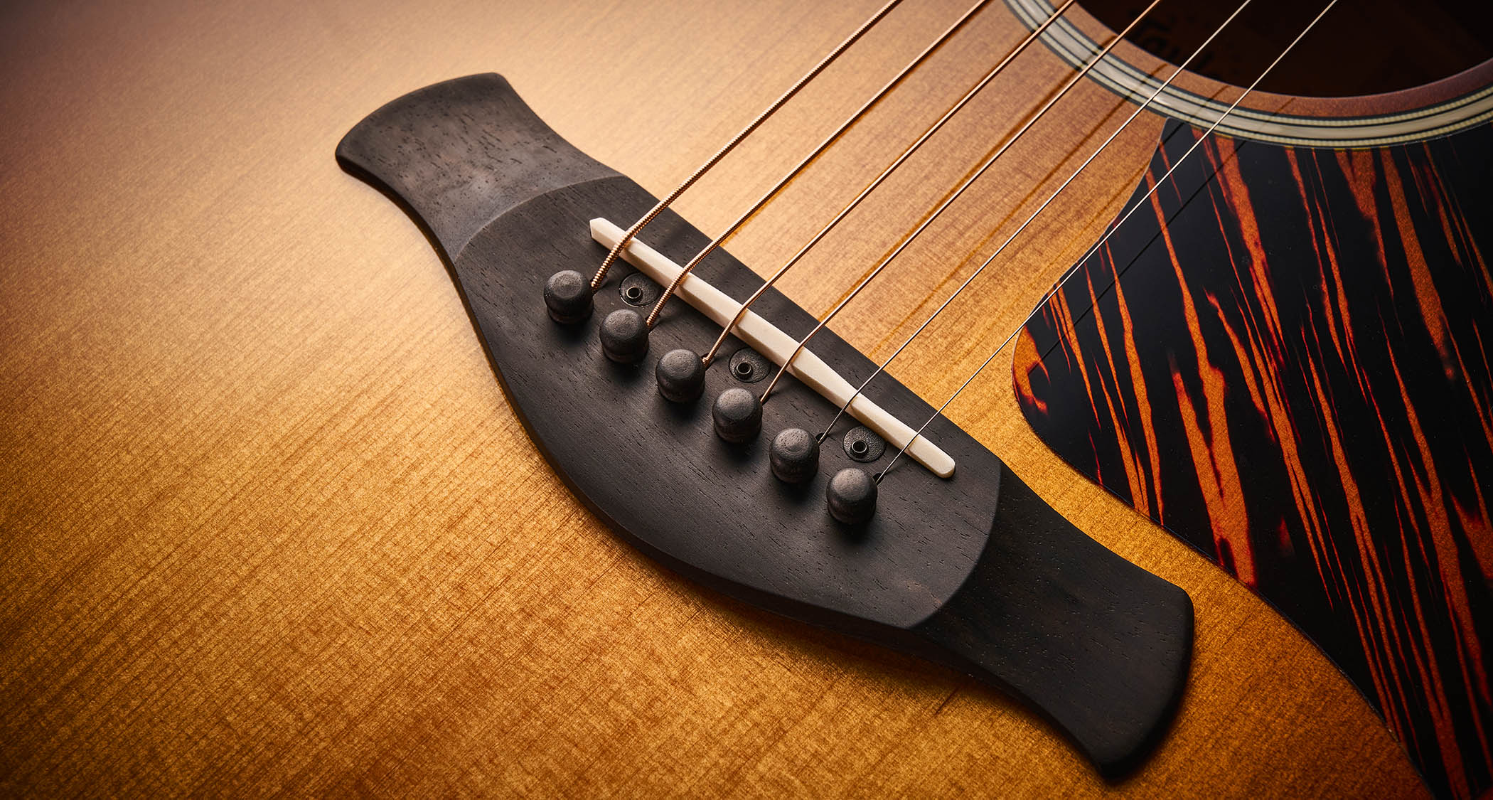 Taylor Builder’s Edition 514ce Kona Burst pictured against a wooden floor and patterned rug.