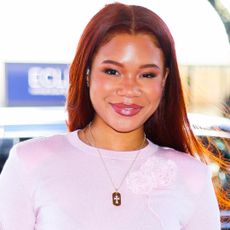 Storm Reid was spotted in NYC wearing a polka-dot bubble-hem skirt, a pale pink crop top, and an oversize Coach Tabby bag