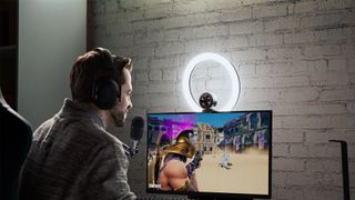 Best ring light hero image showing the Razer ring light and man using it to light up his stream setting while playing a game
