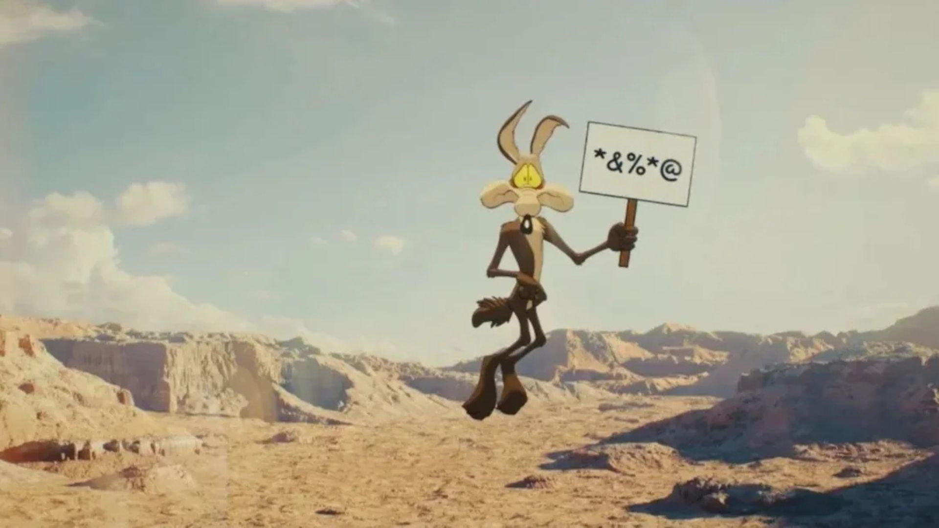 Coyote hovers over a canyon holding a swear sign