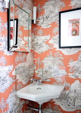 Half bath with bold wallpaper