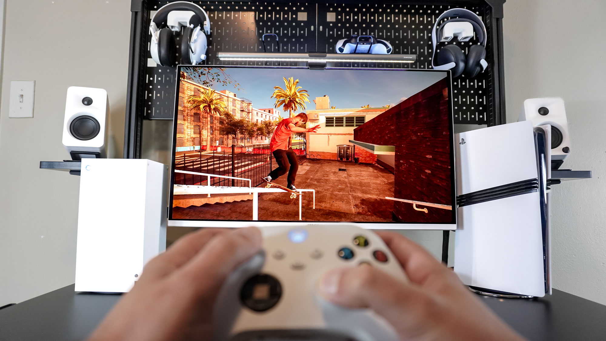 A person playing the skateboarding sim Session on an Xbox Series X at a black-and-white desk setup built around the Corsair Platform:4 Elevate Desk