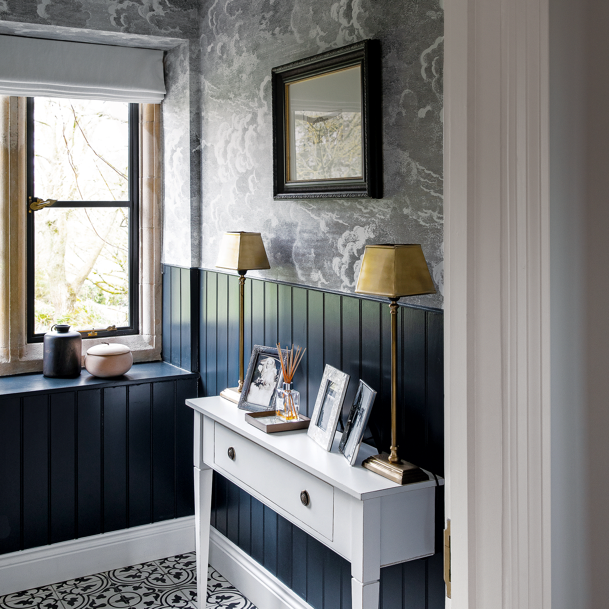 Blue wall panelling with cloudy wallpaper