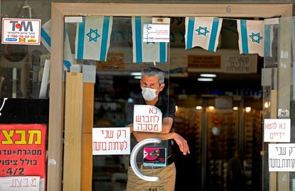 A man wears a mask in Jerusalem.