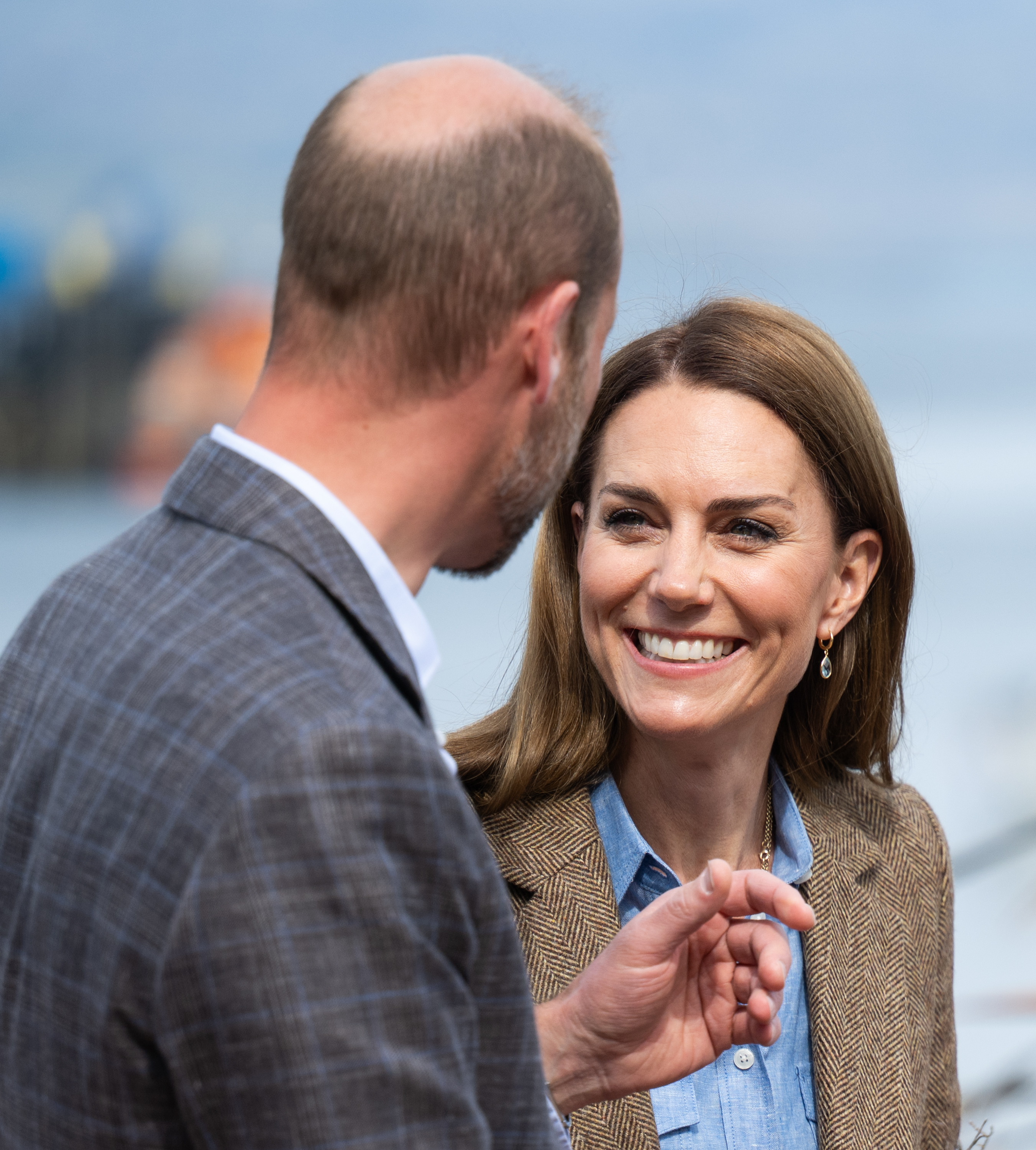 Kate Middleton smiling at Prince William, whose back is to the camera