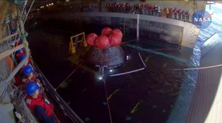 NASA's Artemis 1 Orion spacecraft is brought aboard the USS Portland recovery after splashing down on Dec. 11, 2022.