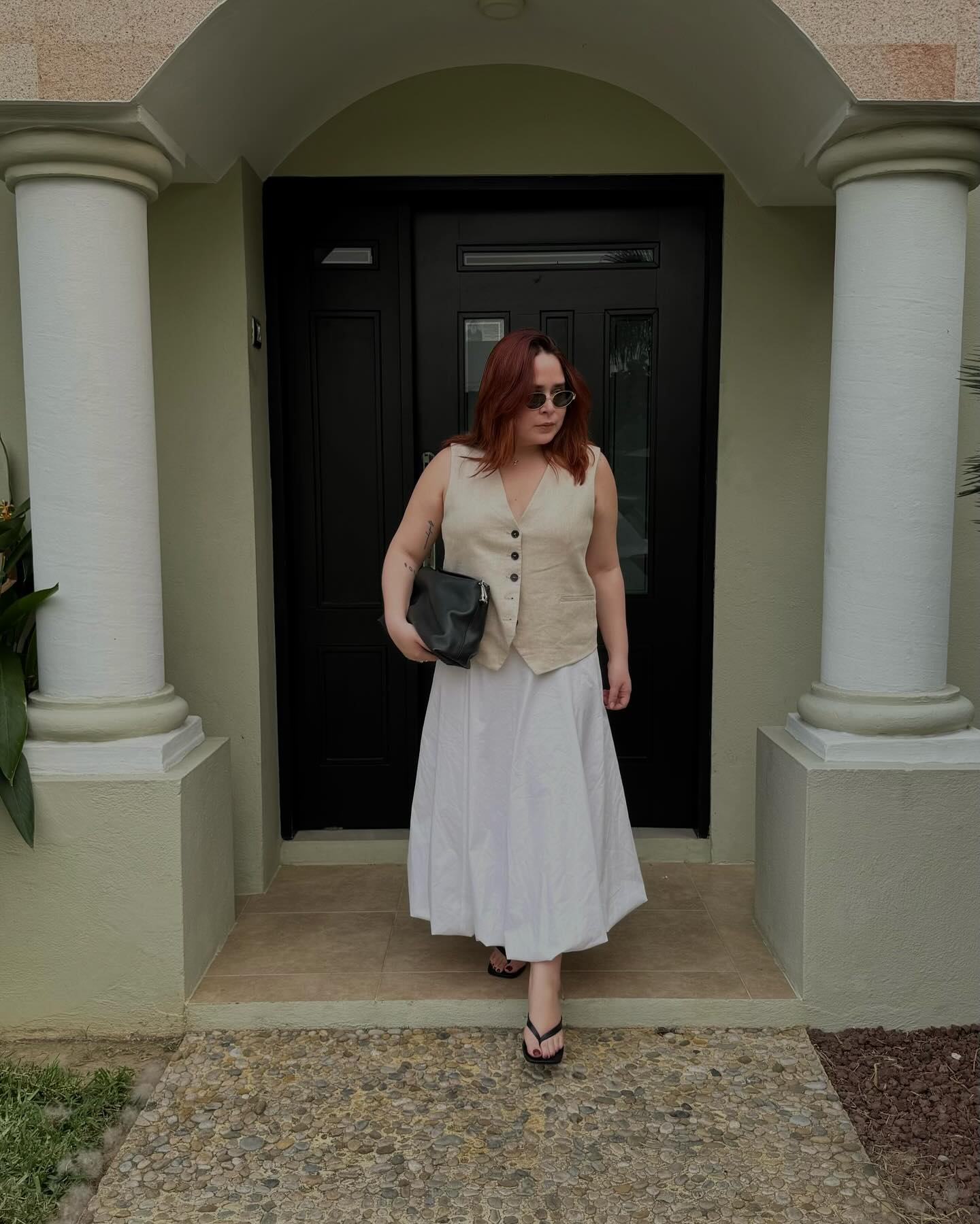 90s capsule wardrobe: @indiraci wears a waistcoat with a maxi skirt and flip flops