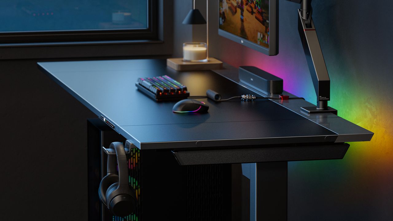 Close up of Magnus Evo desk with PC setup on top and headphones hanging on right hand side.