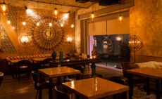 Mr Livanets restaurant in Moscow with leather sofas, industrial lighting and wall art