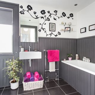 bathroom with grey panelled wall and potted plant