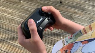Potensic A20 Mini Drone controller, in a young person's hands
