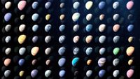 Rows of colorful planets of all colors and sizes over a dark background