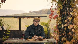 Stanley Tucci at a picnic table in Stanley Tucci: Searching for Italy