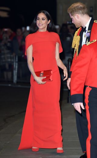 Meghan Markle in red cape dress