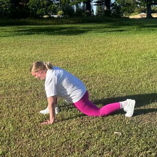 Woman demonstrating active hip flexor stretch