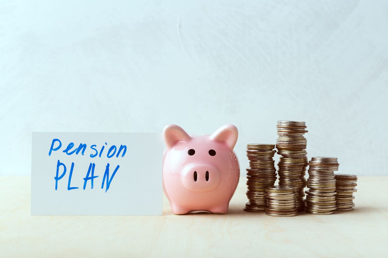 Piggy bank next to coins and sign saying Pension Plan