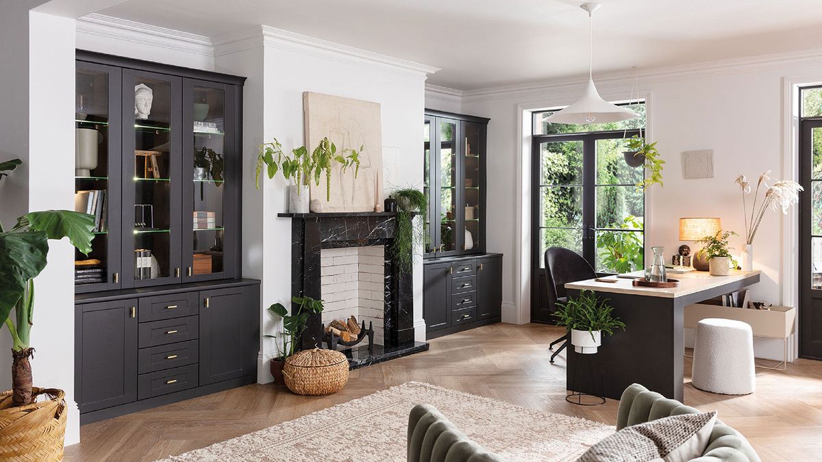 home office with wooden floor and blue furniture and fireplace