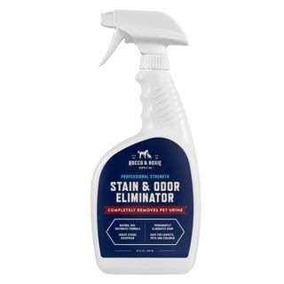 A white plastic spray bottle of stain and odor eliminator with a blue label 