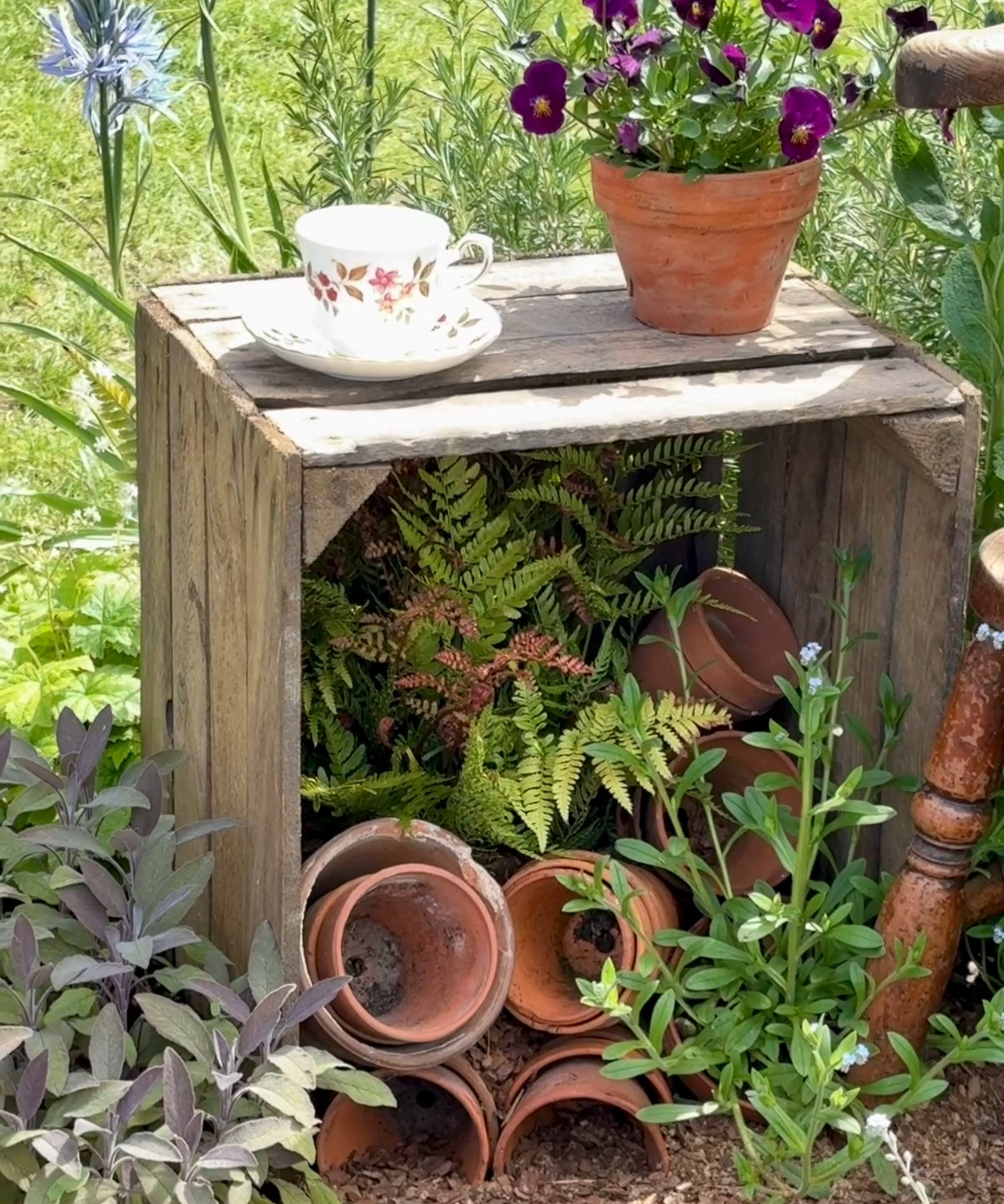 Bug hotel made with crate and terracotta pots