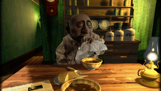 A strange man sits at a table