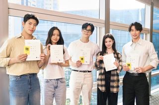 The cast of 'Can This Love Be Translated?" pose while holding scripts.