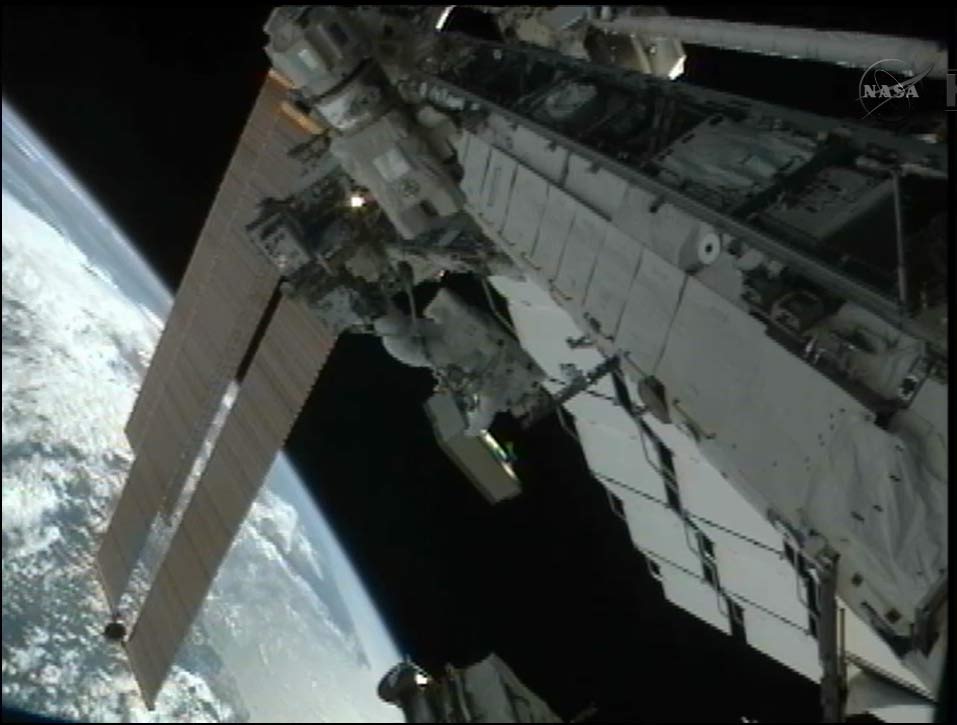 Spacewalker Akihiko Hoshide on Robotic Arm During Spacewalk