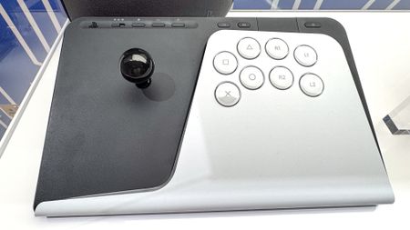 PlayStation FlexStrike Wireless Fight Stick in a glass cabinet