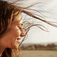 Cropped view of a young woman with the wind in her hair