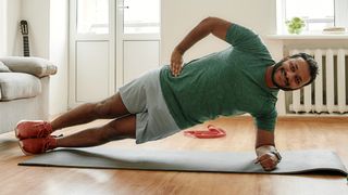 A man holds the side plank position