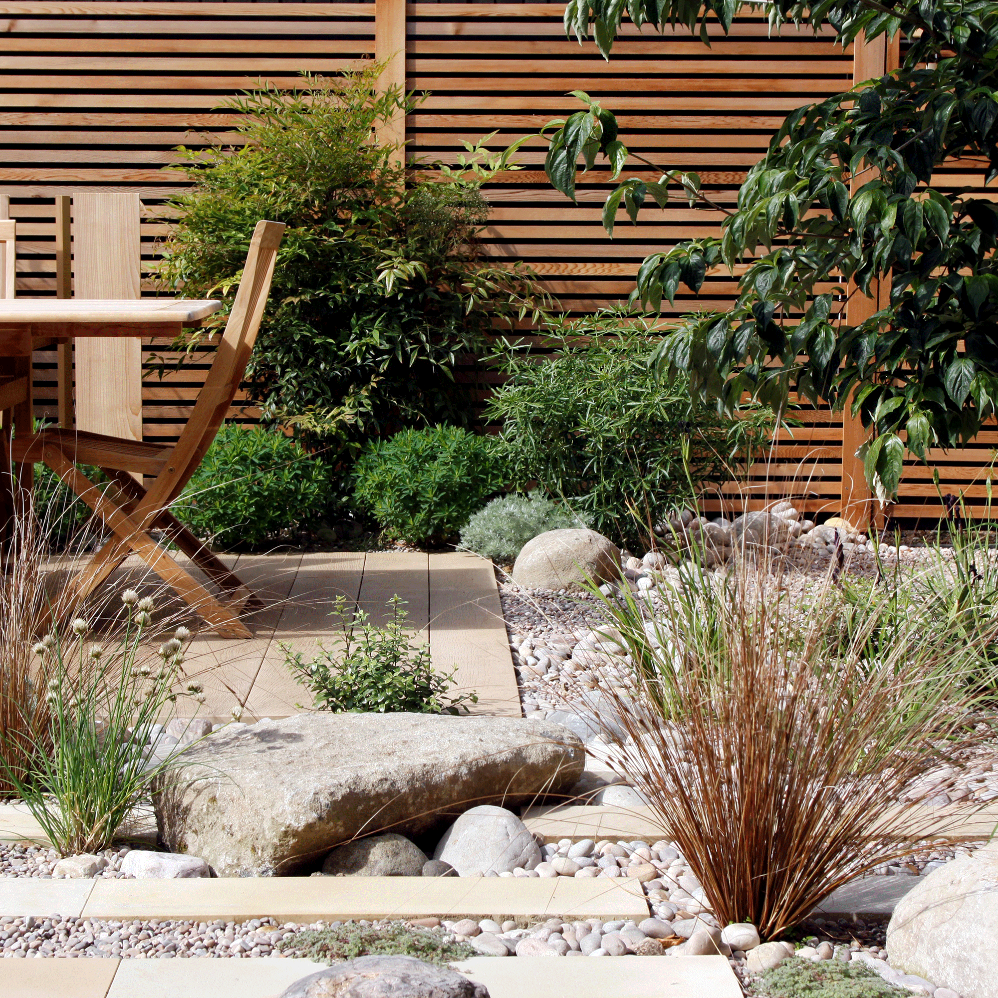 Rock garden with wooden furniture