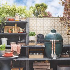 An outdoor kitchen with a tiled splashback detail