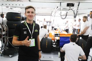 Simon Yates stands behind Fernando Alonso's car at the French Grand Prix