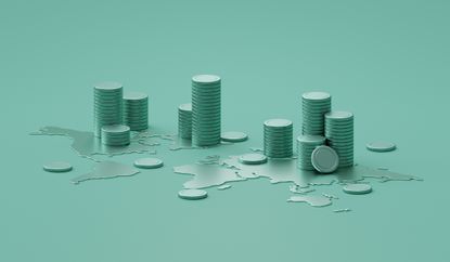 Stacks of coins piled on a world map representing global investing