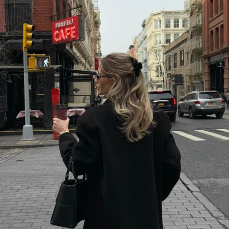 Fredrika Ekerot in a black coat and Bottega Veneta bag